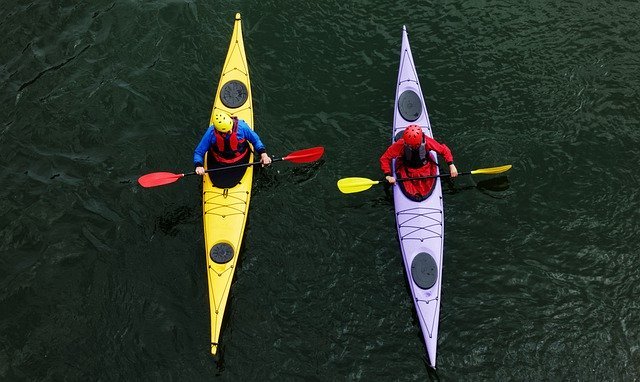 Aerial photo of two sea kayakers in long, skinny kayaks pausing for a chat