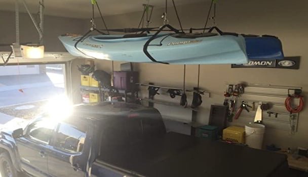 Kayak storage ceiling hoist system from tie boss. kayaks stored over a pick-up.